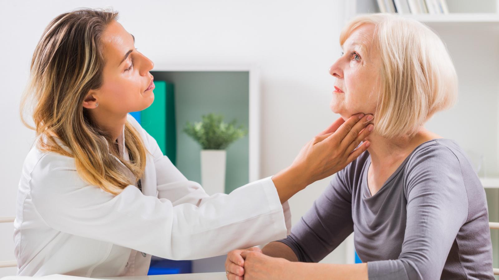 Woman having her throat examined by a doctor