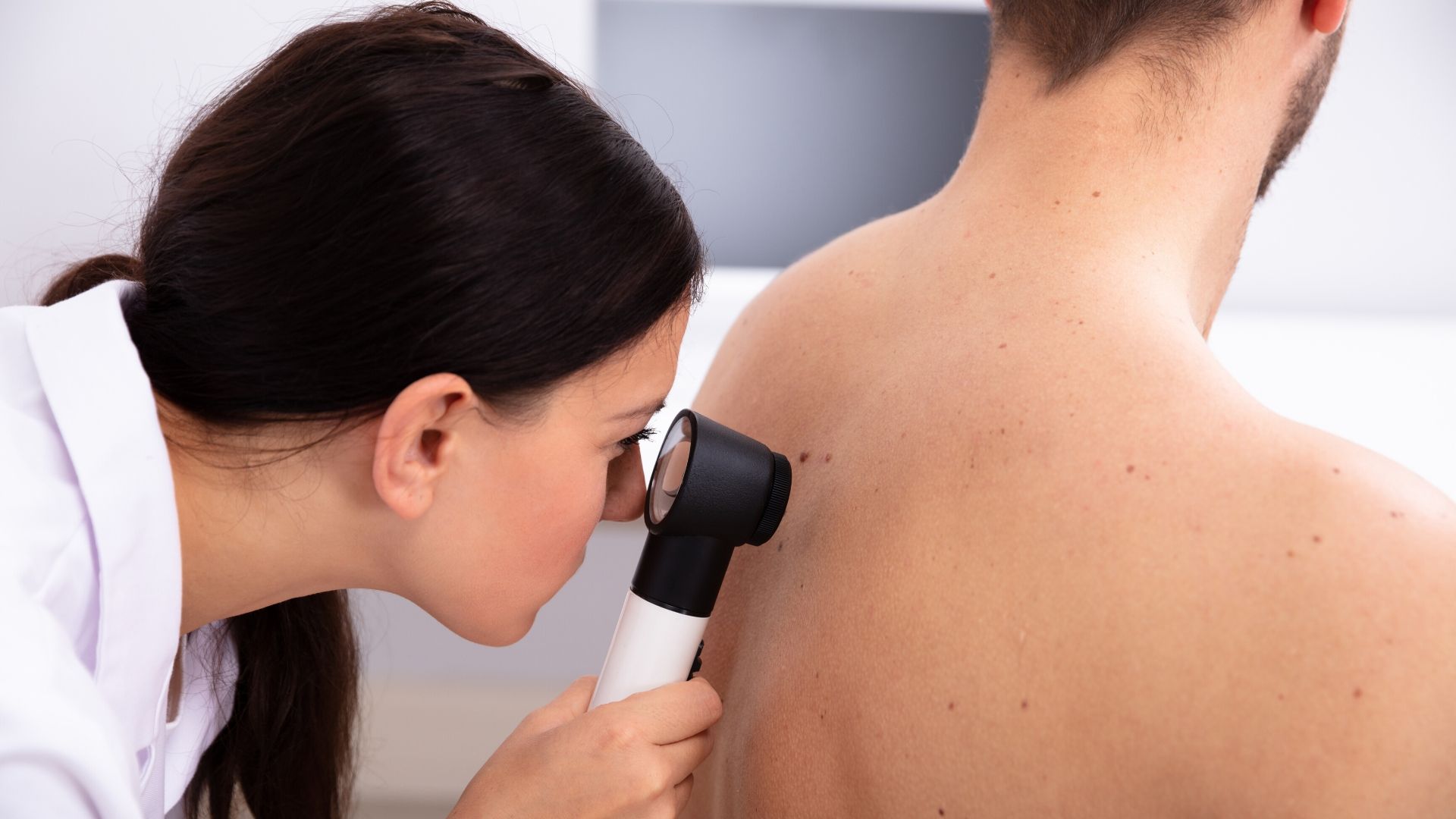 Dermatologist examining skin