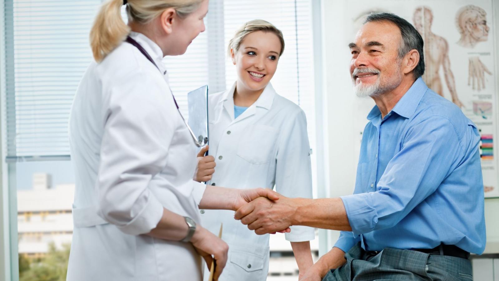Doctor and nurse greeting patient
