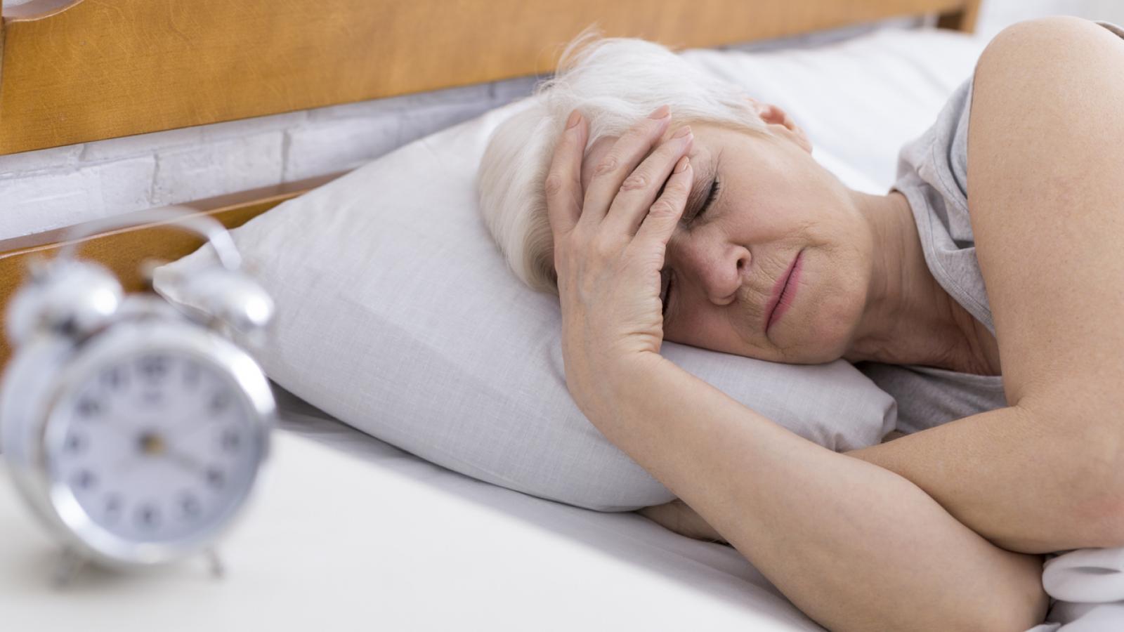 Older woman in bed having trouble sleeping