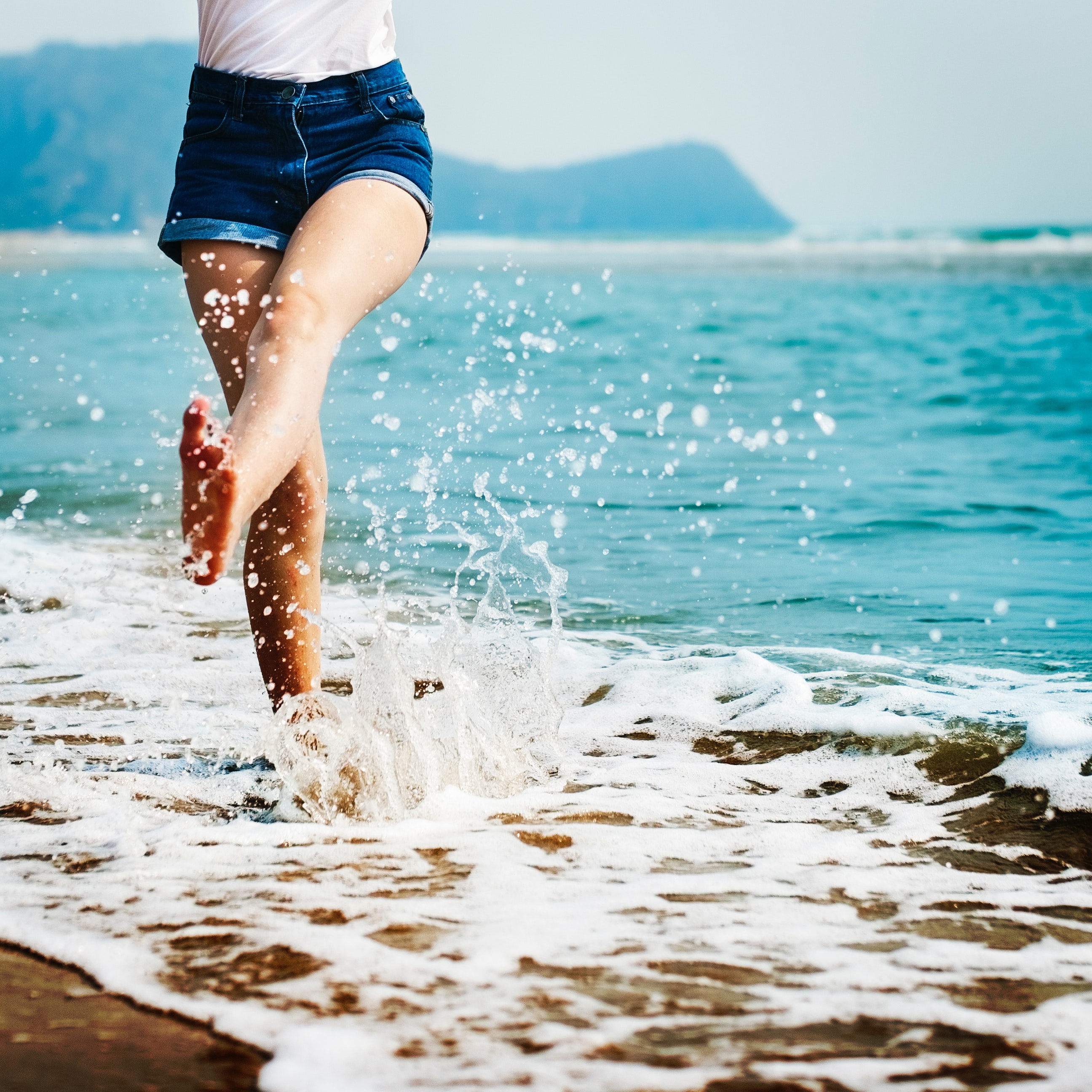 Woman barefoot on the beach
