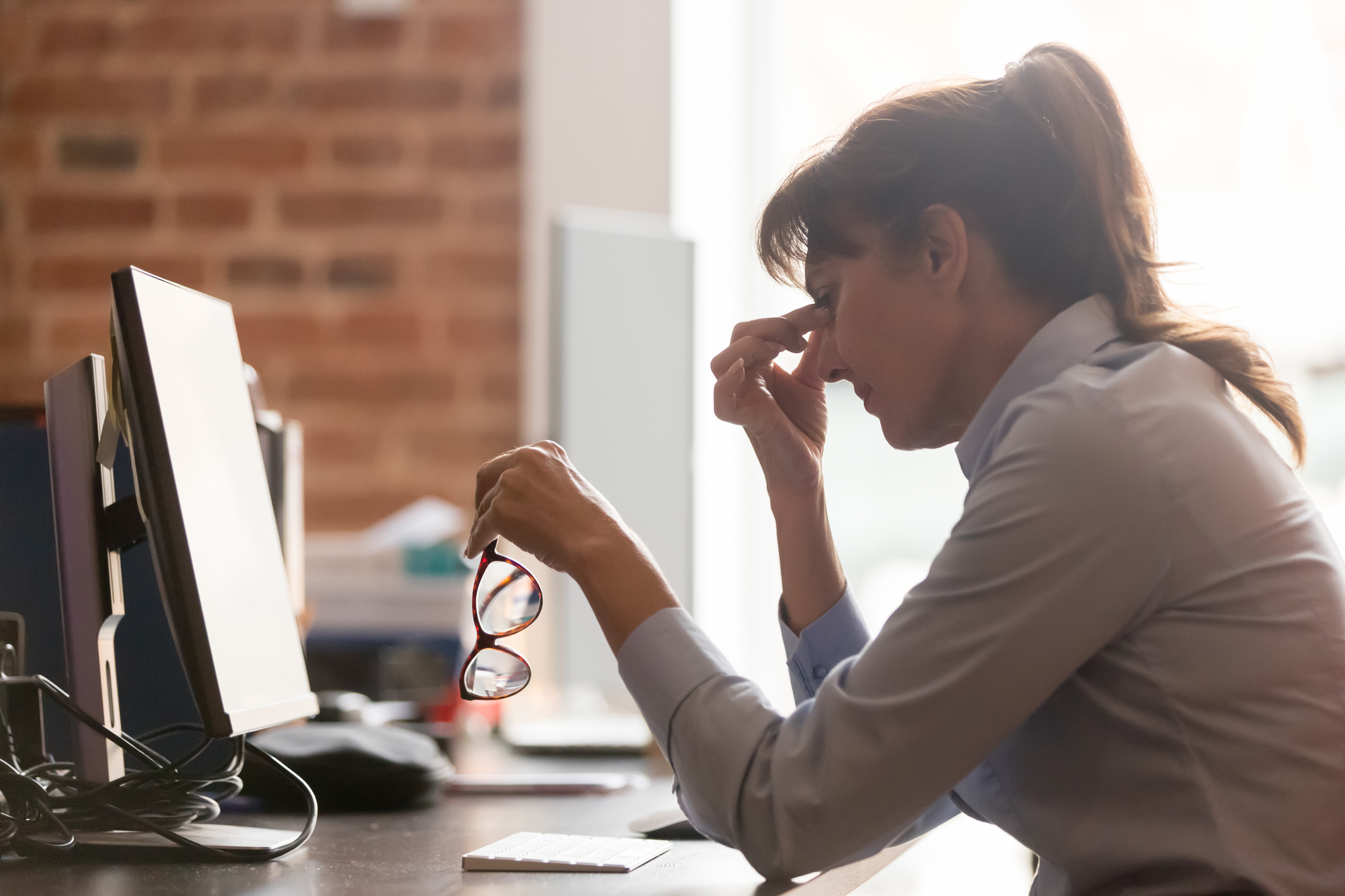 Woman in pain at her desk