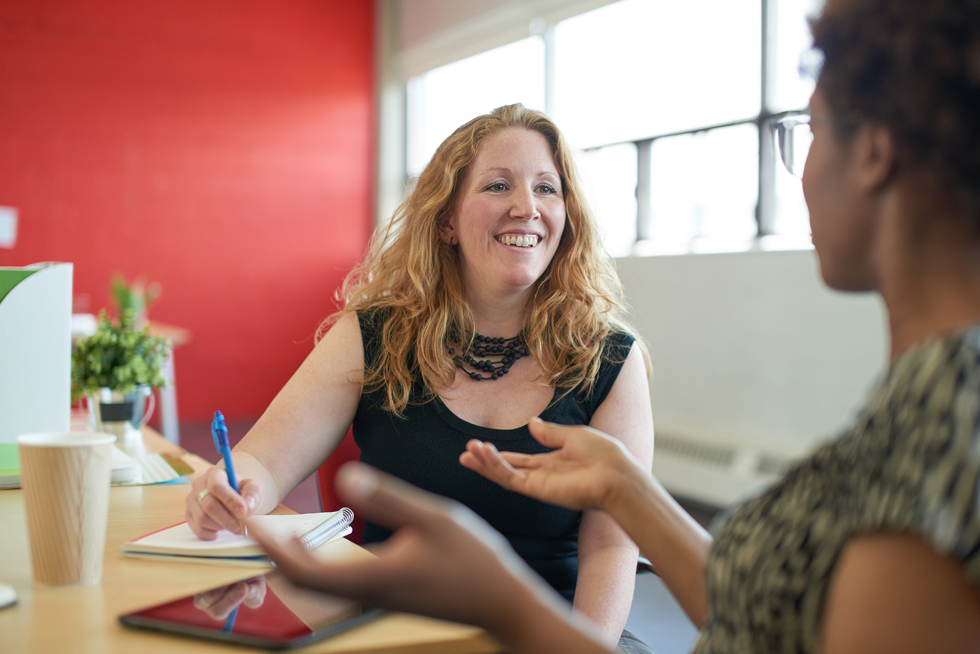 Two women talking at work