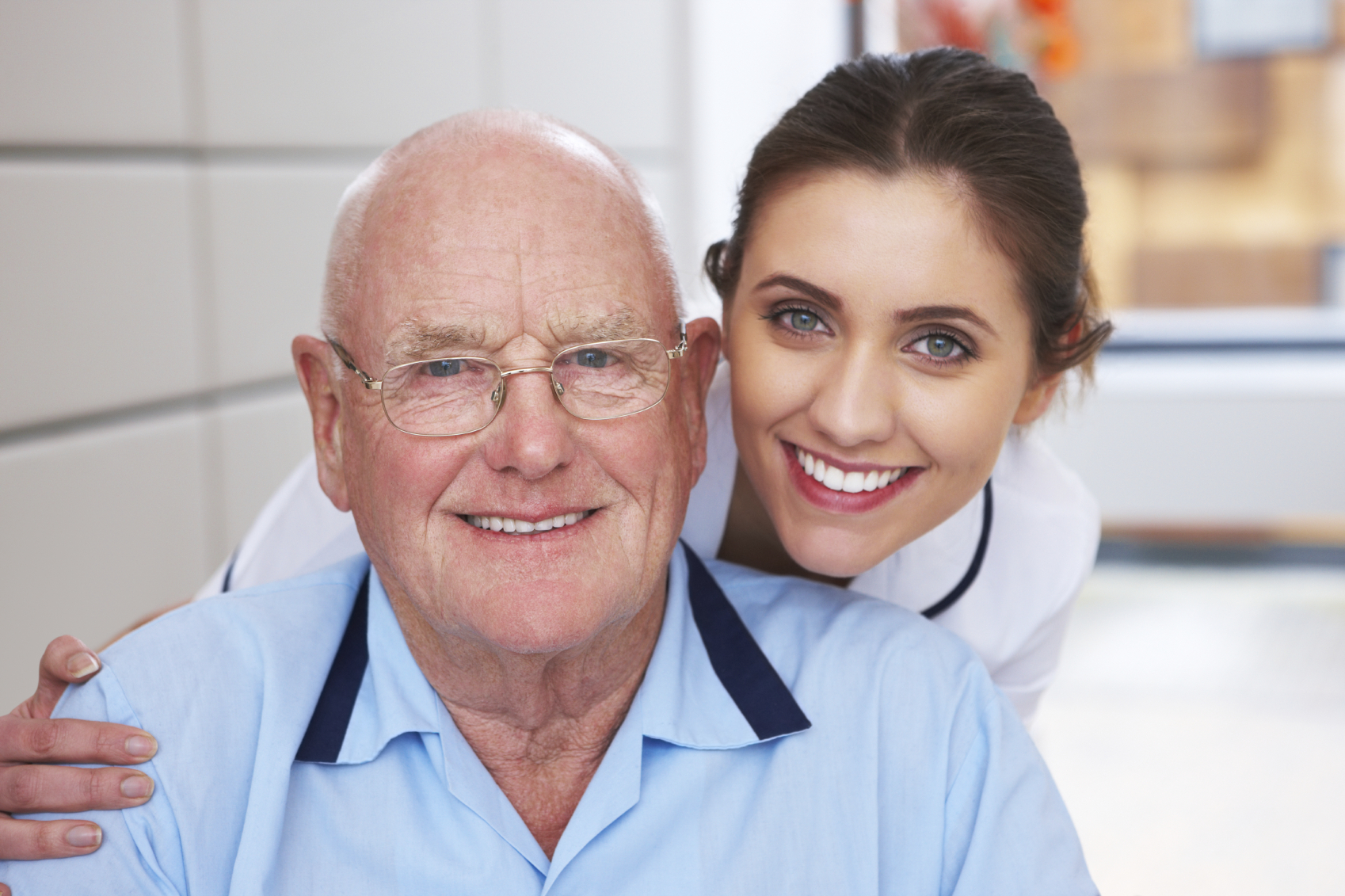 Older man and young female doctor smiling