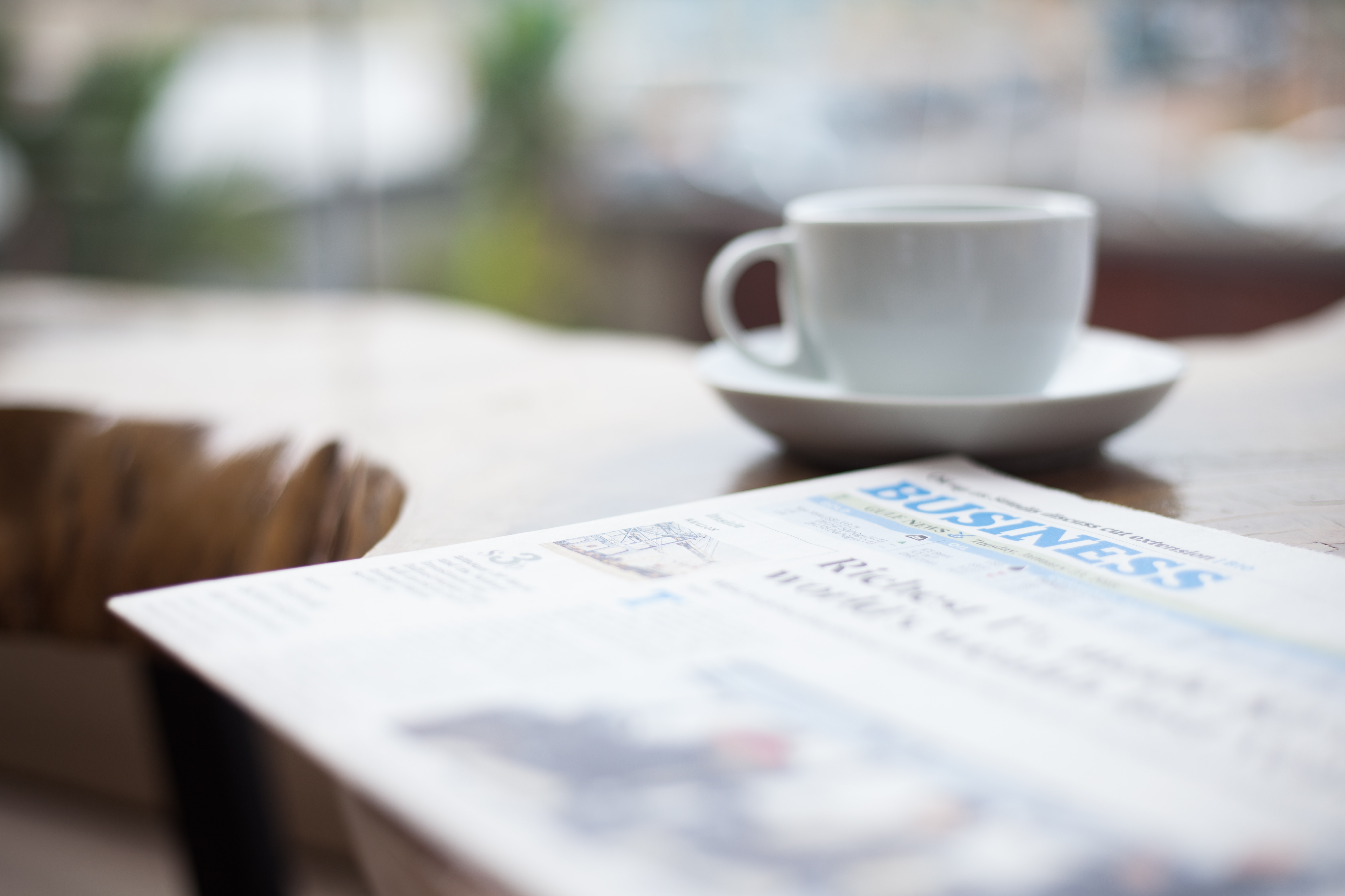 Newspaper and coffee cup