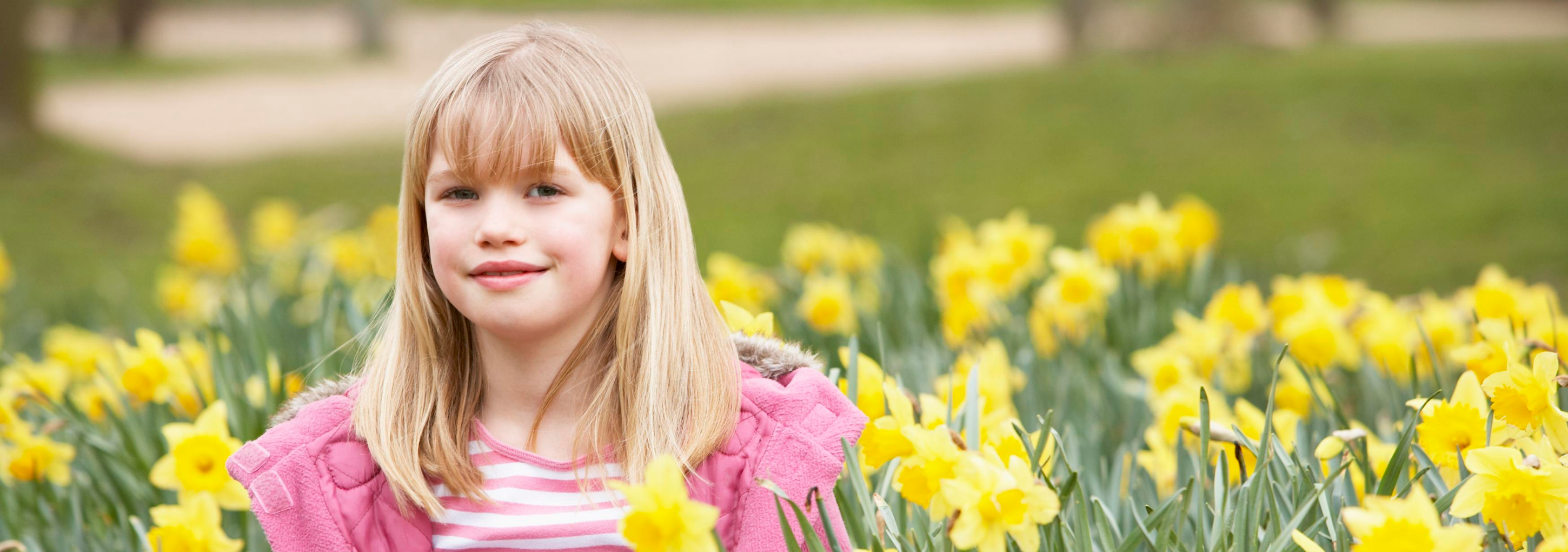 Girl surrounded by daffodils