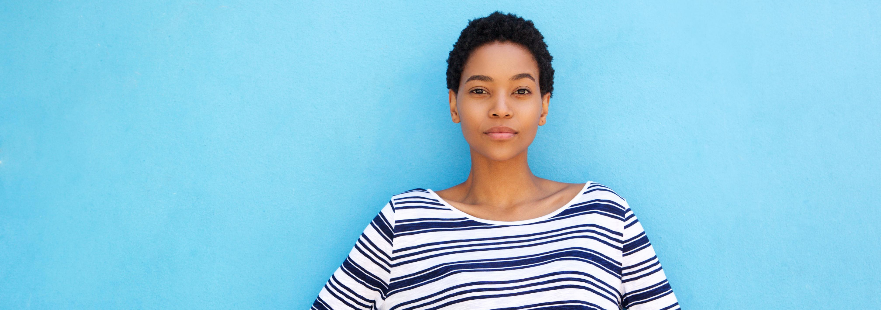 Woman standing beside wall