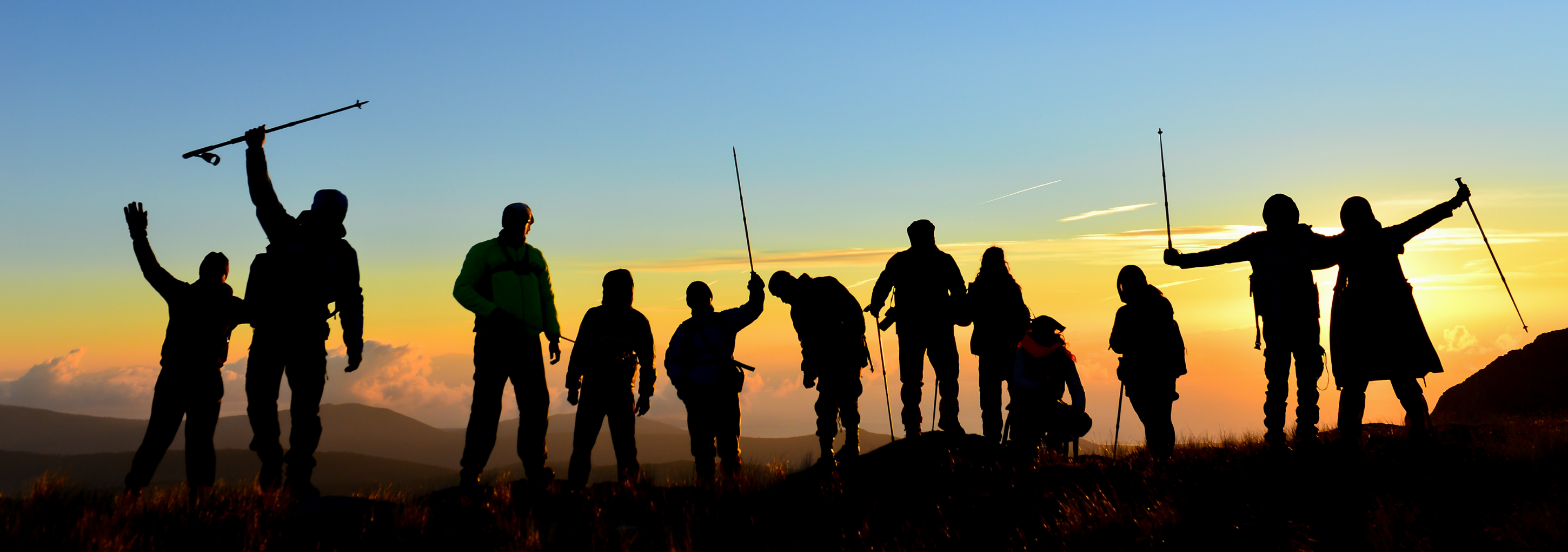 Group hiking at sunset