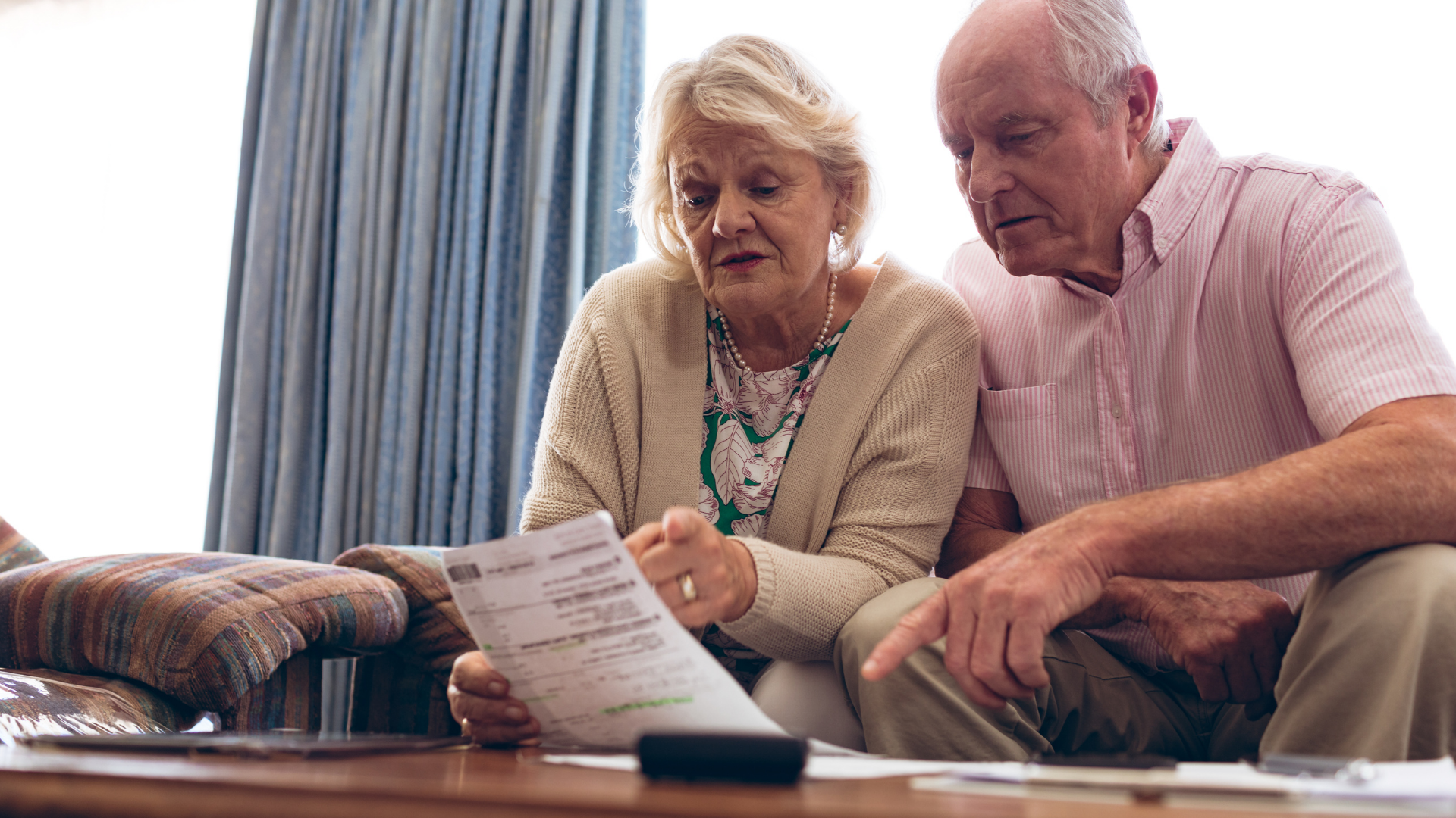 older couple reading bills