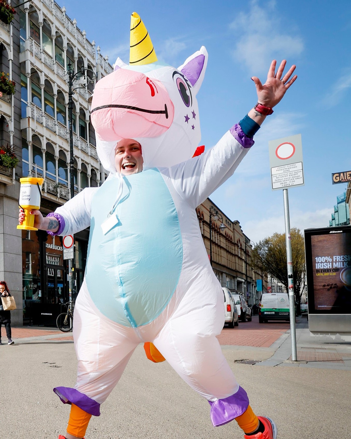 Tara, one of our incredible fundraisers dressed as a unicorn, jumps in the air while fundraising for Daffodil Day!