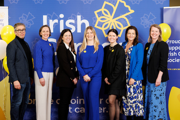 Seven senior leadership team members pictured in front of a blue background