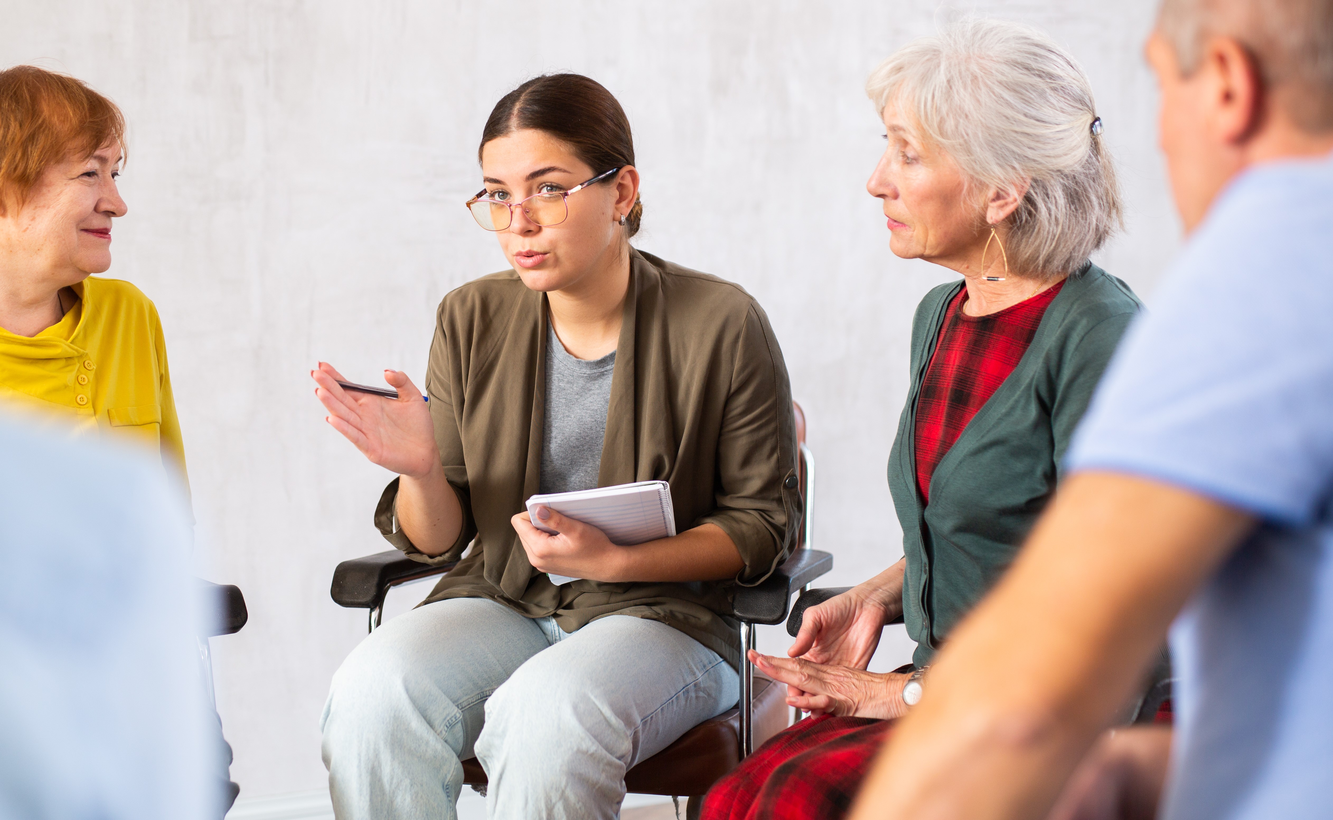 Young woman doing group training for mature people stock photo