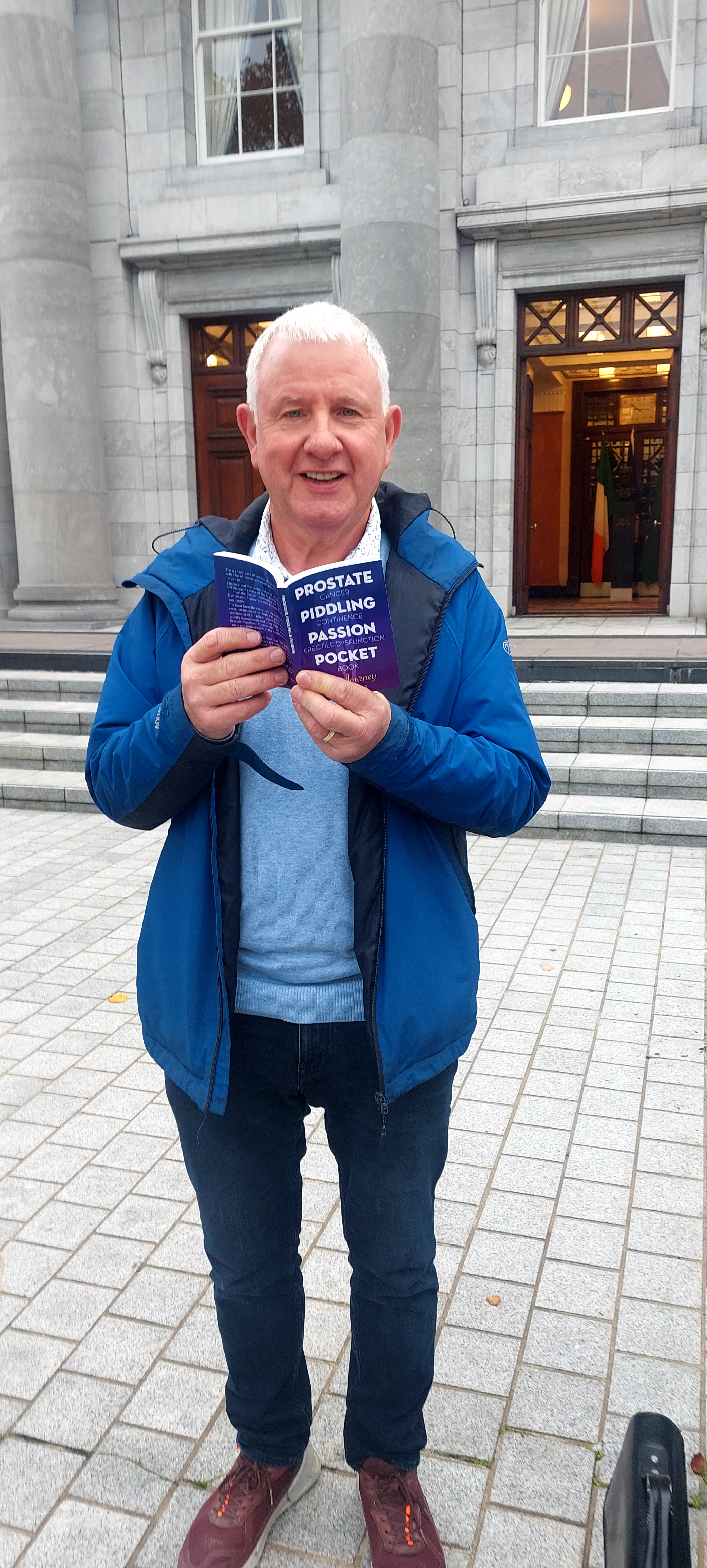 Gerry Kelly holding his book