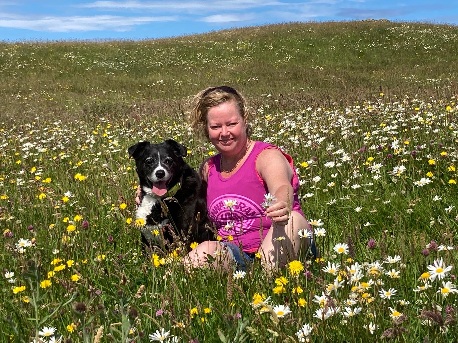 Trish Blake With Dog in Bed of Flowers