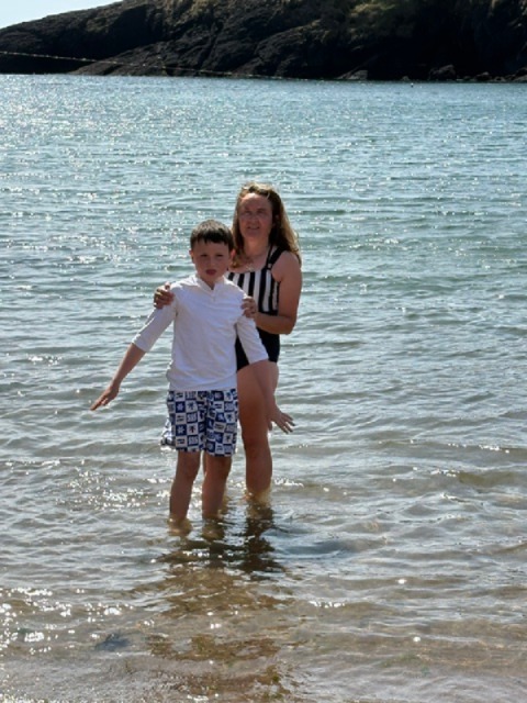 Andrea in the sea with her son