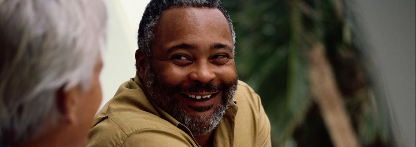 Older black man talking to another person