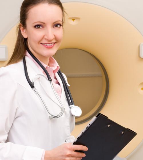 Doctor standing in front of a radiotherapy machine