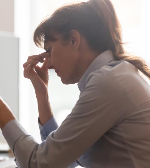 Woman in pain at her desk