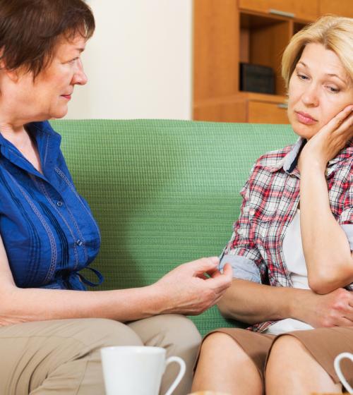 Two mothers talking over tea