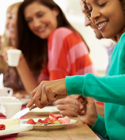 Friends gathered around table with food and coffee