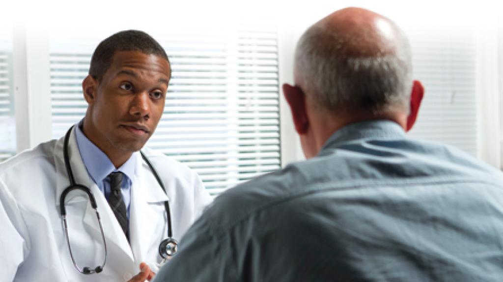 Doctor talking to a male patient
