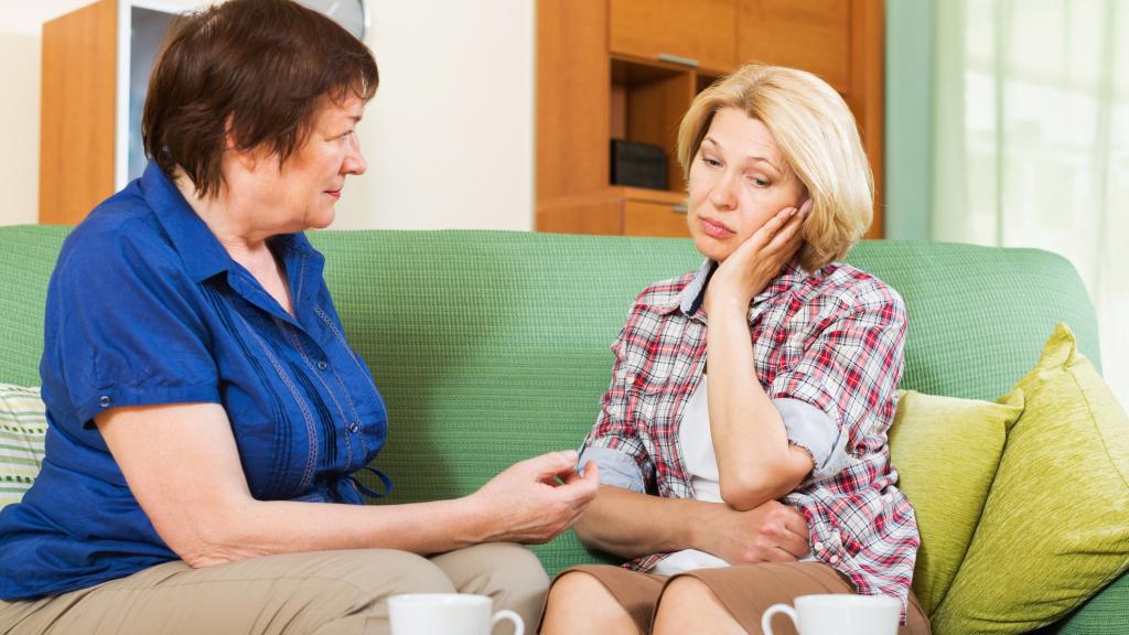 Two mothers talking over tea