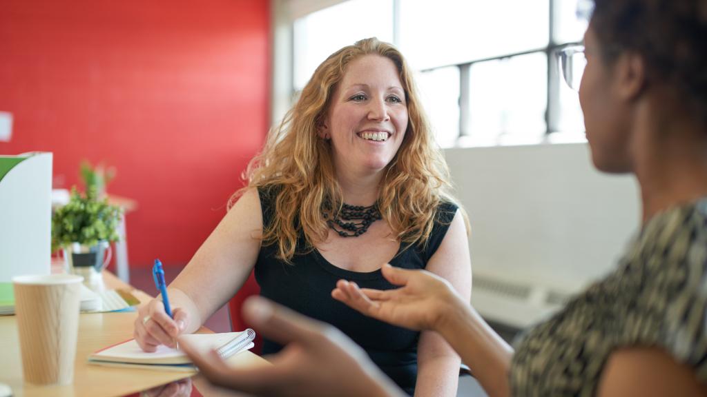 Two women talking at work
