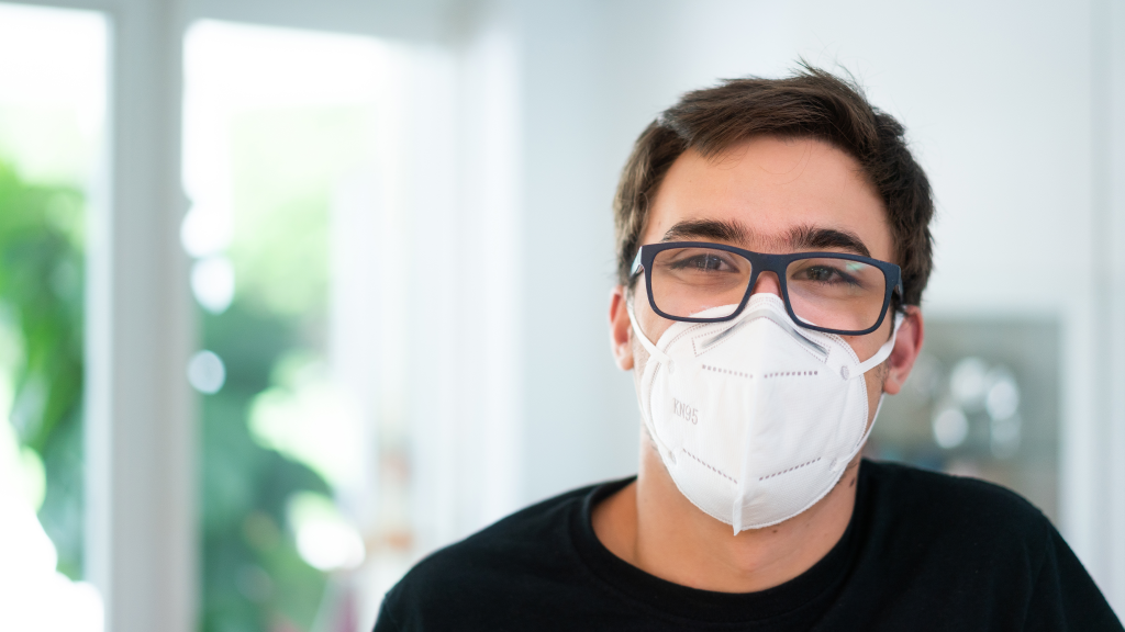 young white man with glasses and a mask