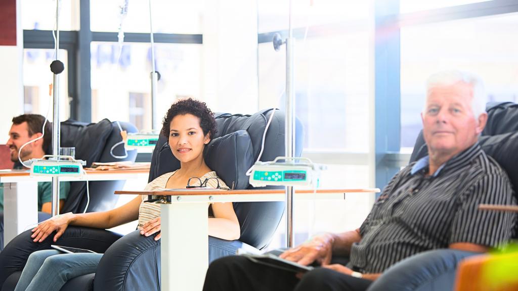 Patients receiving chemotherapy showing a man and a woman receiving chemotherapy via a drip