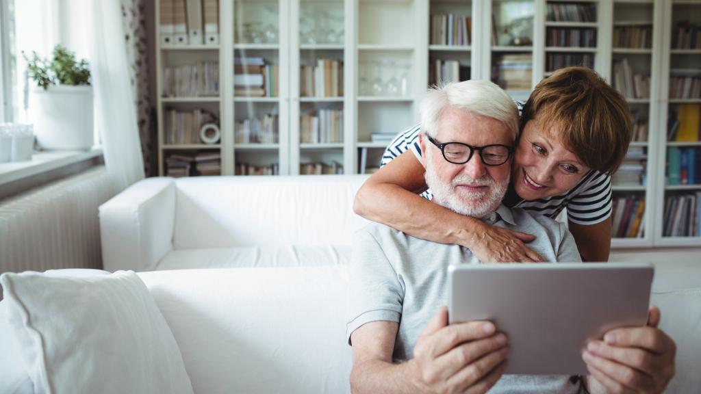 happy older couple with tablet
