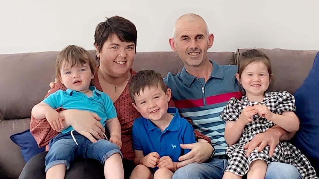 A photo of Bianca Cahalan and her family, sitting on their sofa