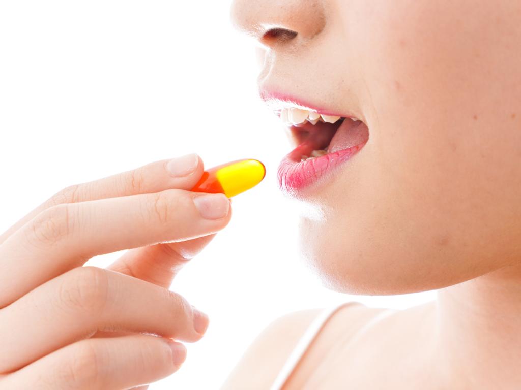 Woman taking a pill