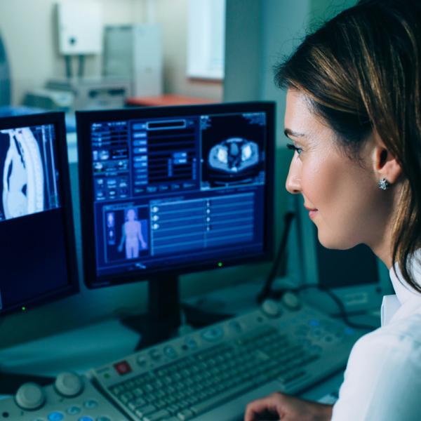 Doctor looking at scan pictures on a computer screen