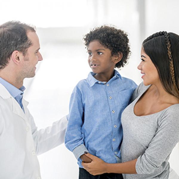 Doctor talking to a mother and her young son
