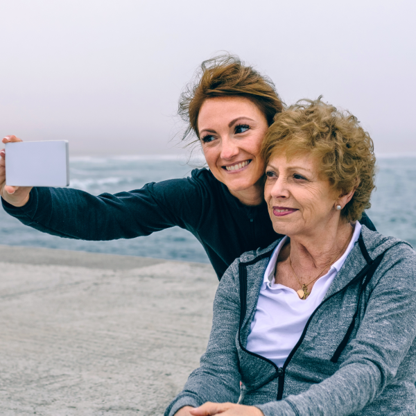 Older woman with daughter taking selfie Canva