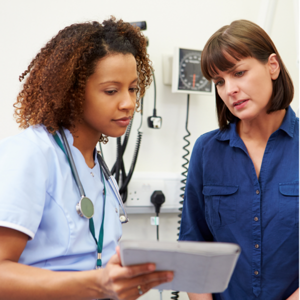 black female nurse explaining to white female patient
