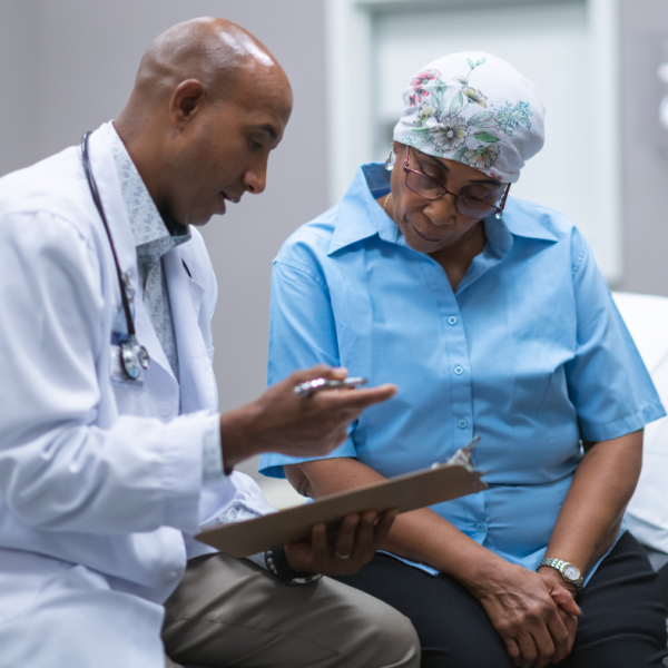 older black woman breast cancer patient speaking with black male doctor