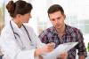 Doctor explaining something to a male patient