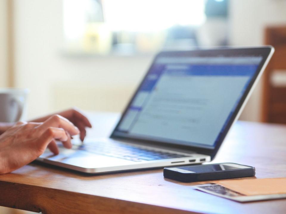 Typing on a laptop