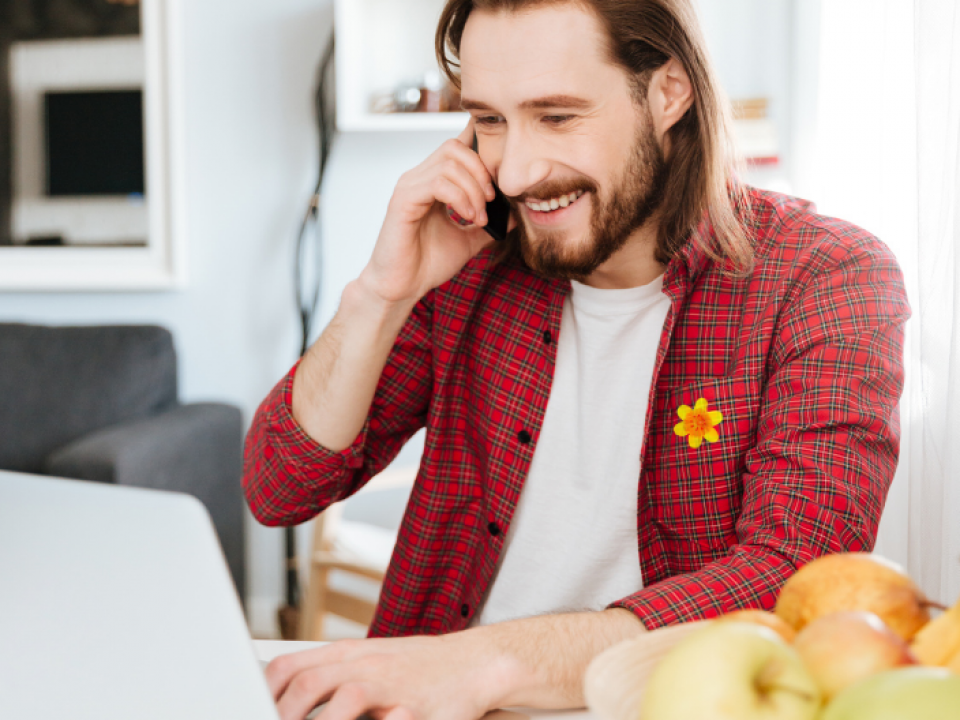 Man using phone and laptop