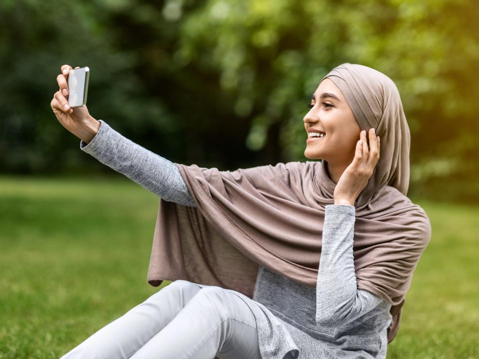 Woman taking selfie with phone
