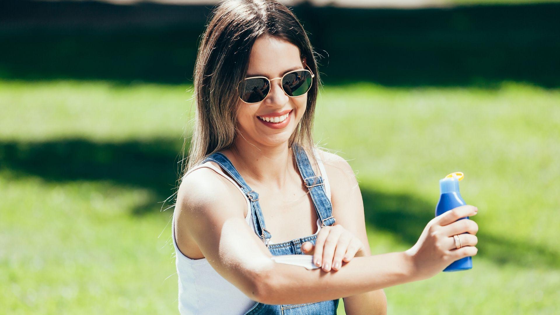Woman applying sunscreen