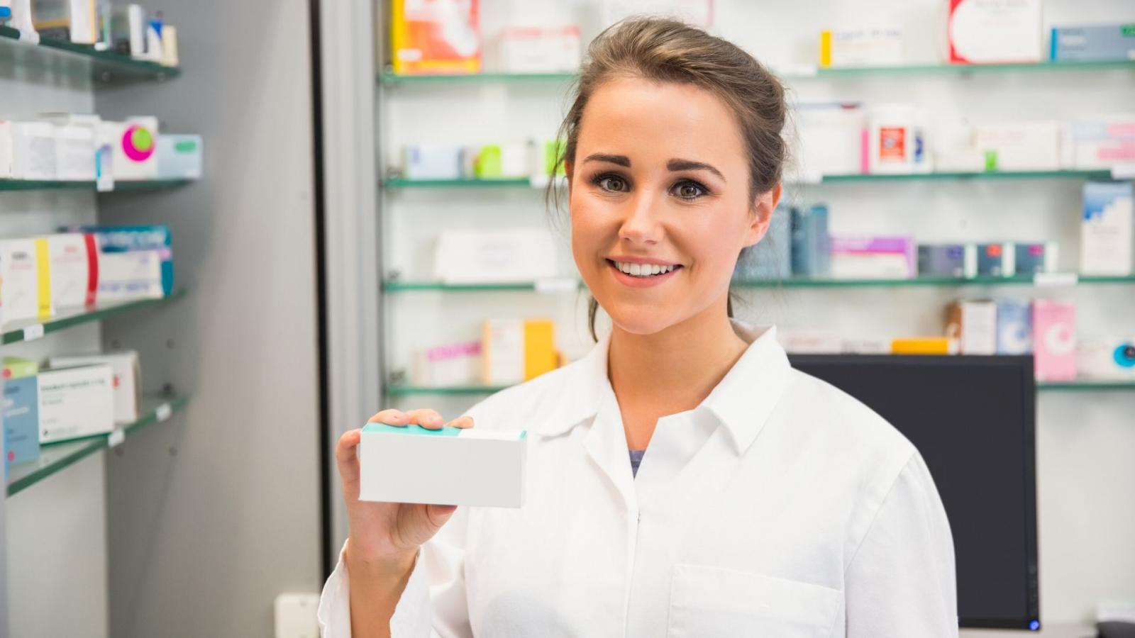 Pharmacist holding box of pills