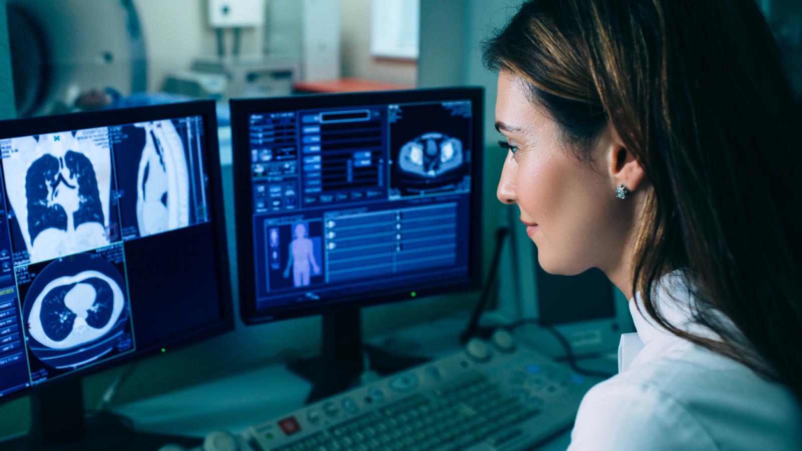 Doctor looking at scan pictures on a computer screen