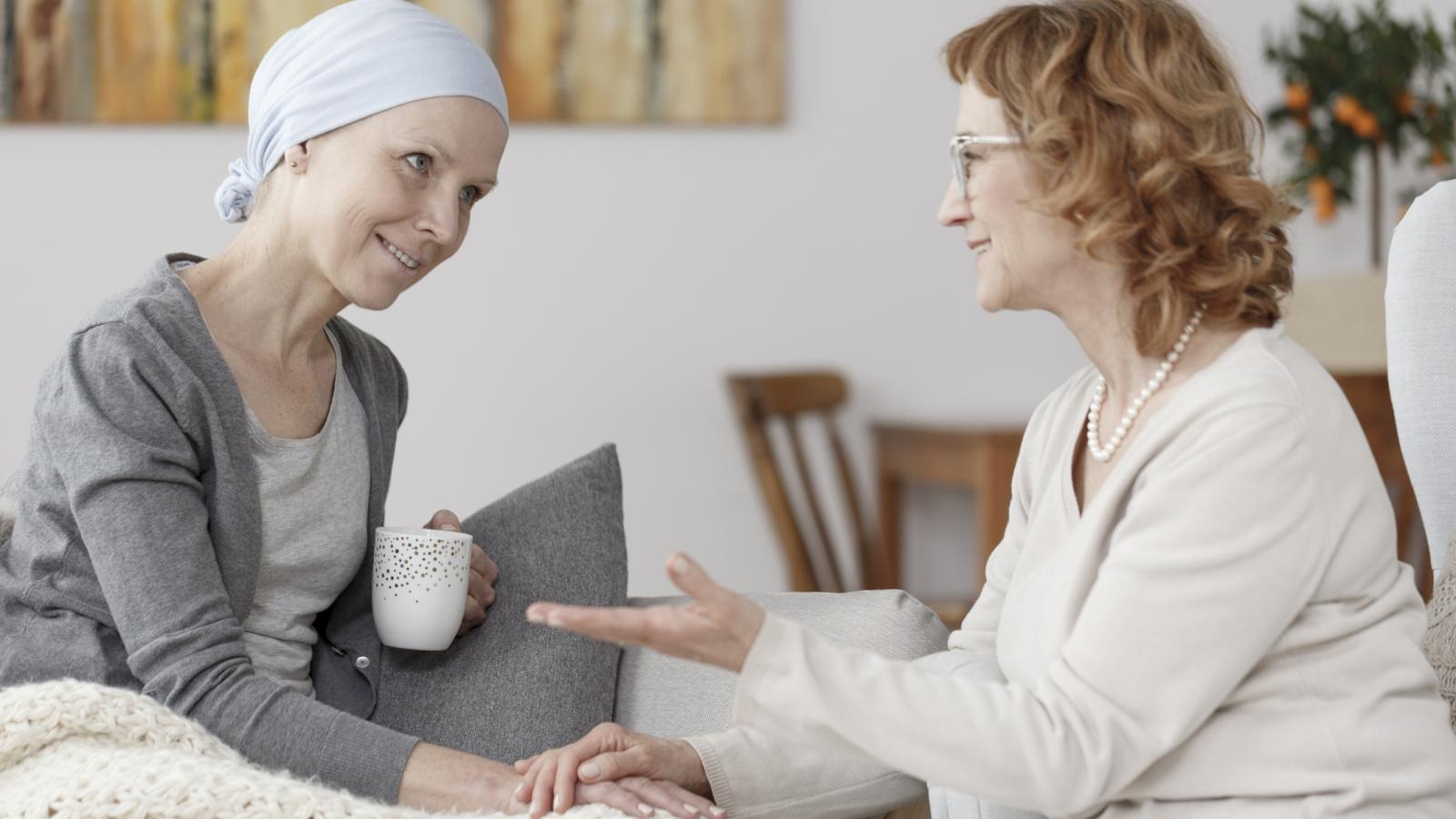 Cancer patient sitting with a nurse
