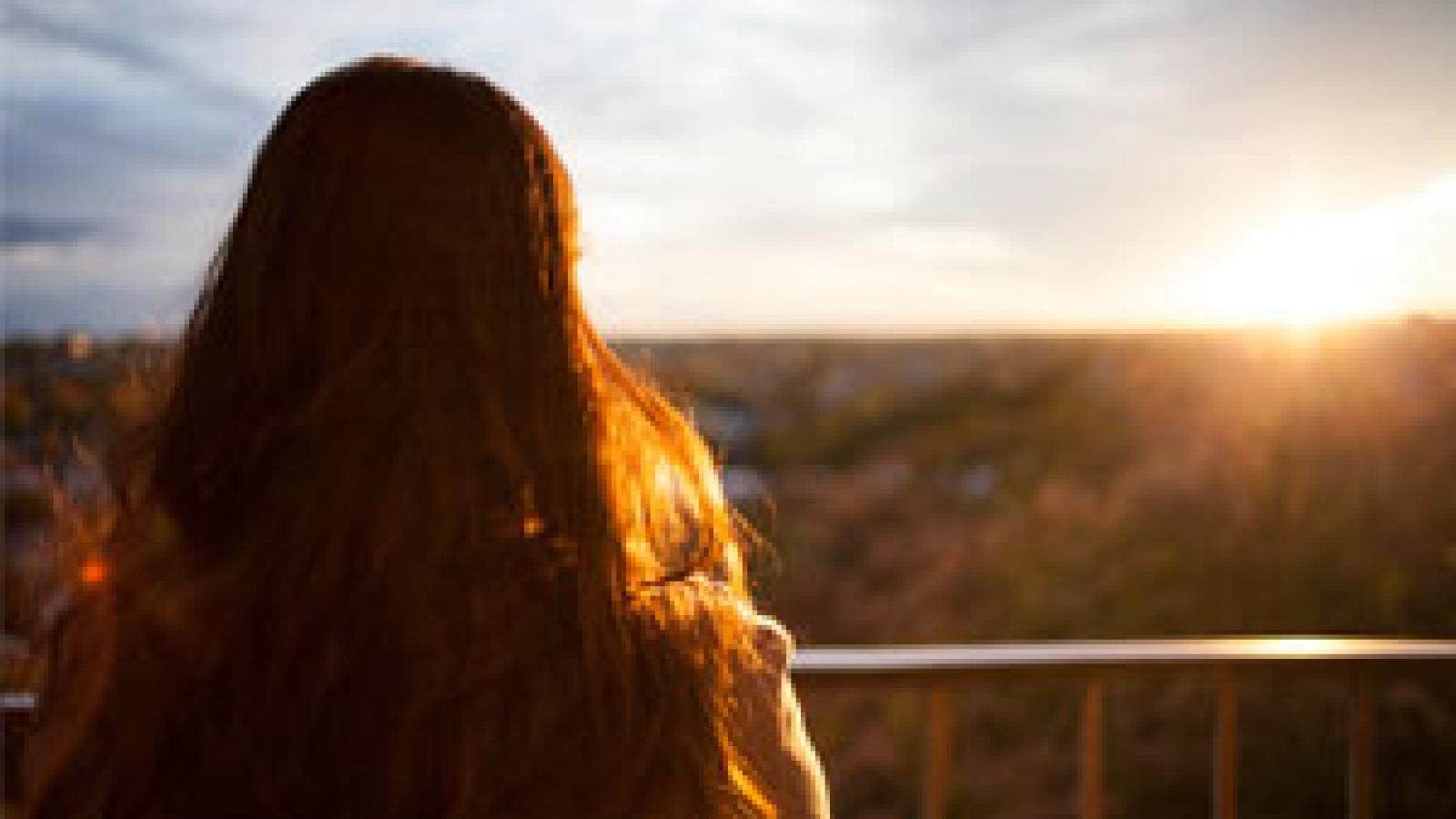 Woman looking at a sunset