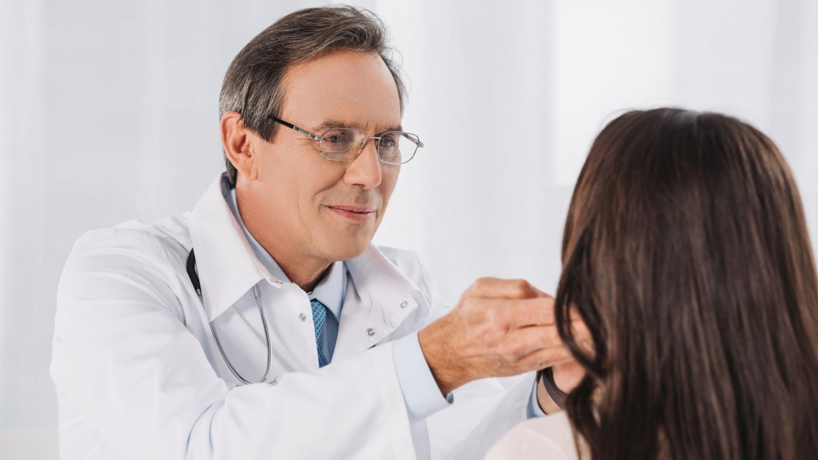 Doctor checking lymph nodes
