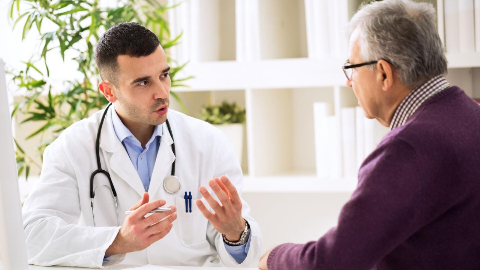Young male doctor explaining something to an older man