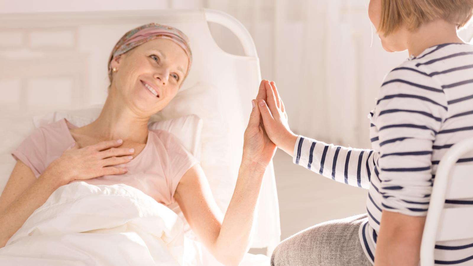 Daughter with sick mother in bed