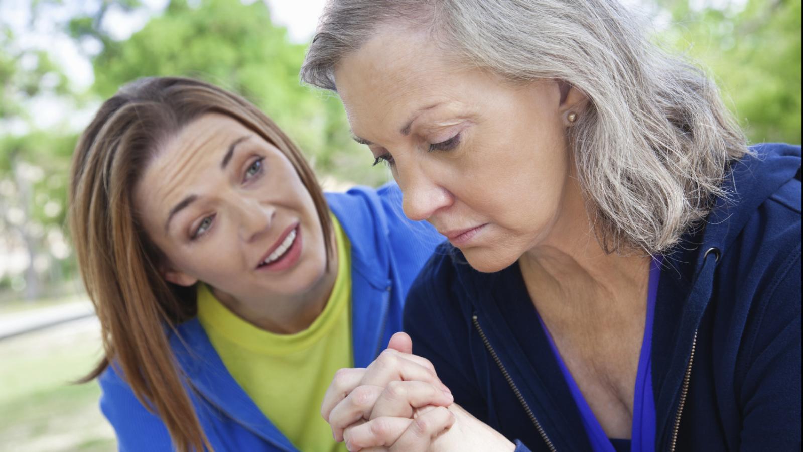 A woman talking to another upset woman